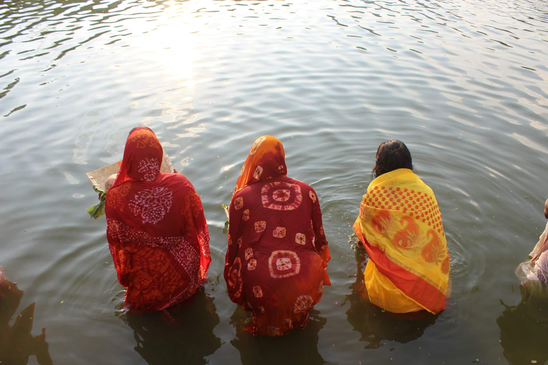 Women Entering the River for Worship During Chhath Festival